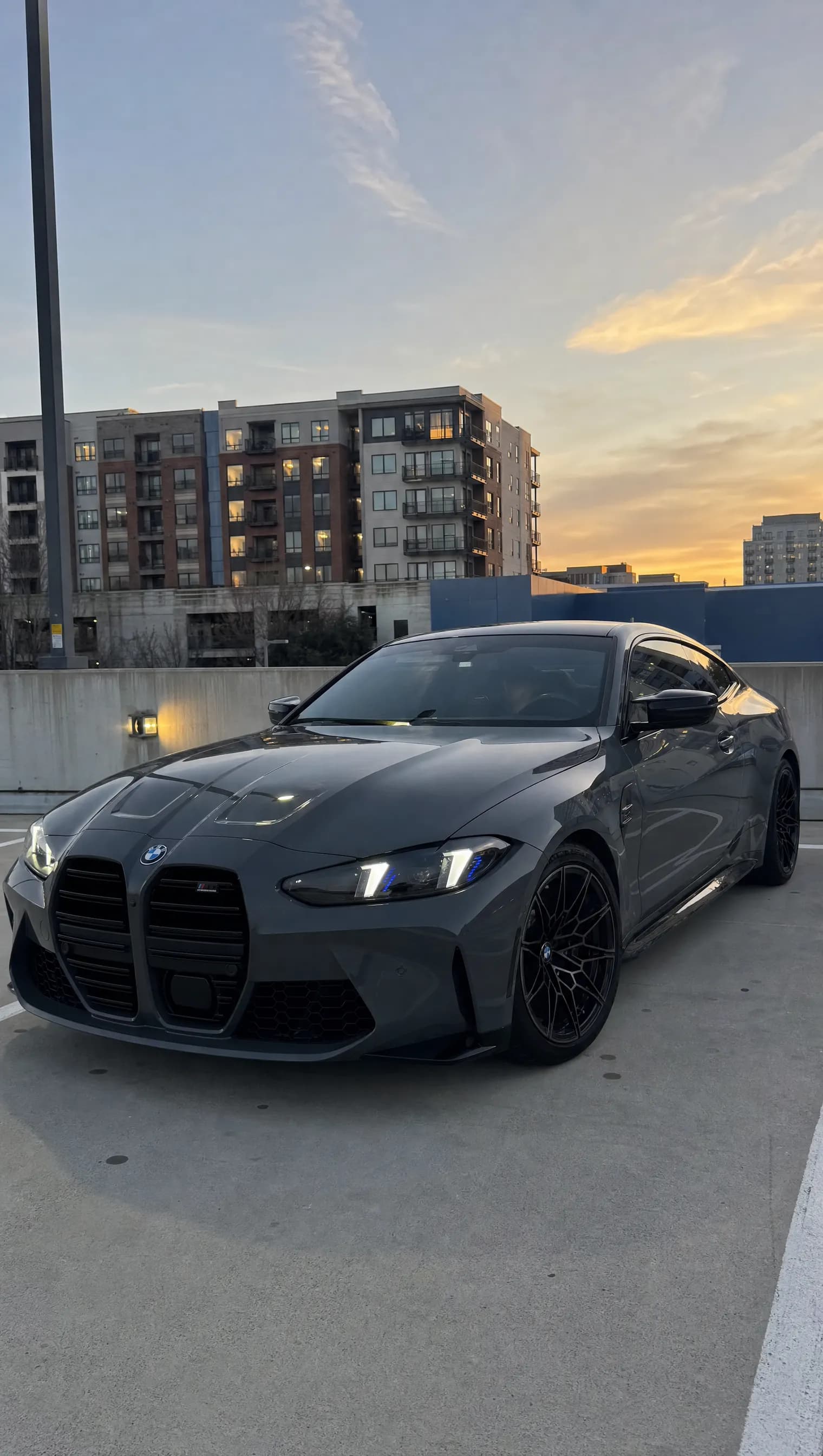 BMW G82 M4 with CSL-Style Arrow-DRL headlights in white DRL mode — front quarter view