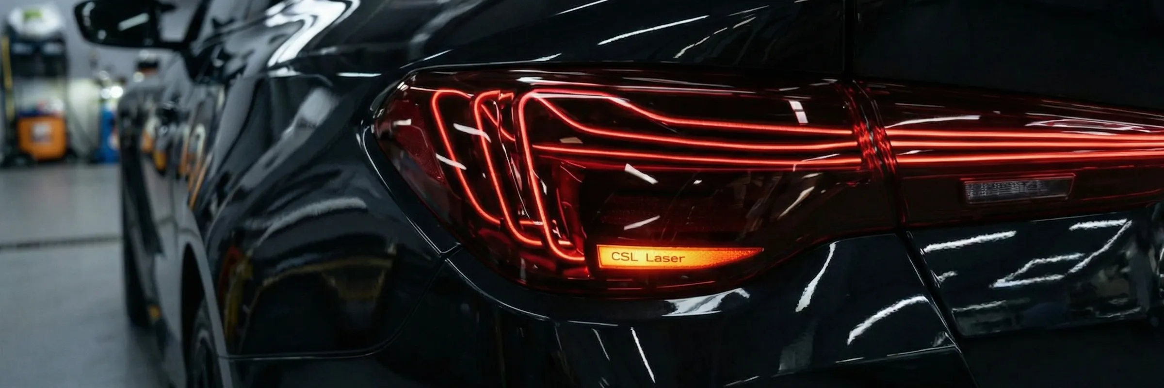 BMW G22 with CSL laser-style LED taillights installed — intersecting filament signature lit