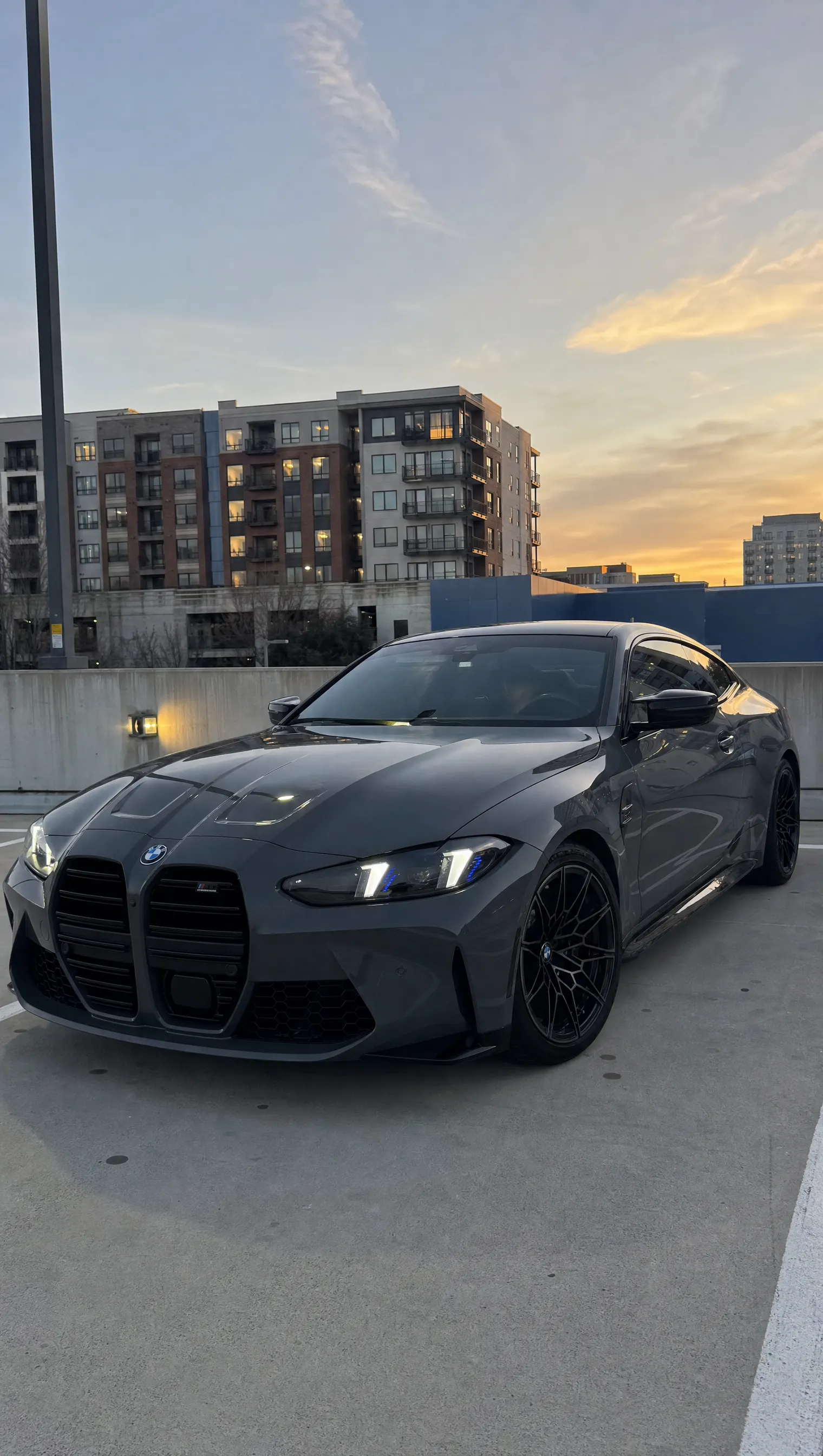 BMW G82 M4 with CSL-Style Arrow-DRL headlights in white DRL mode — front quarter view